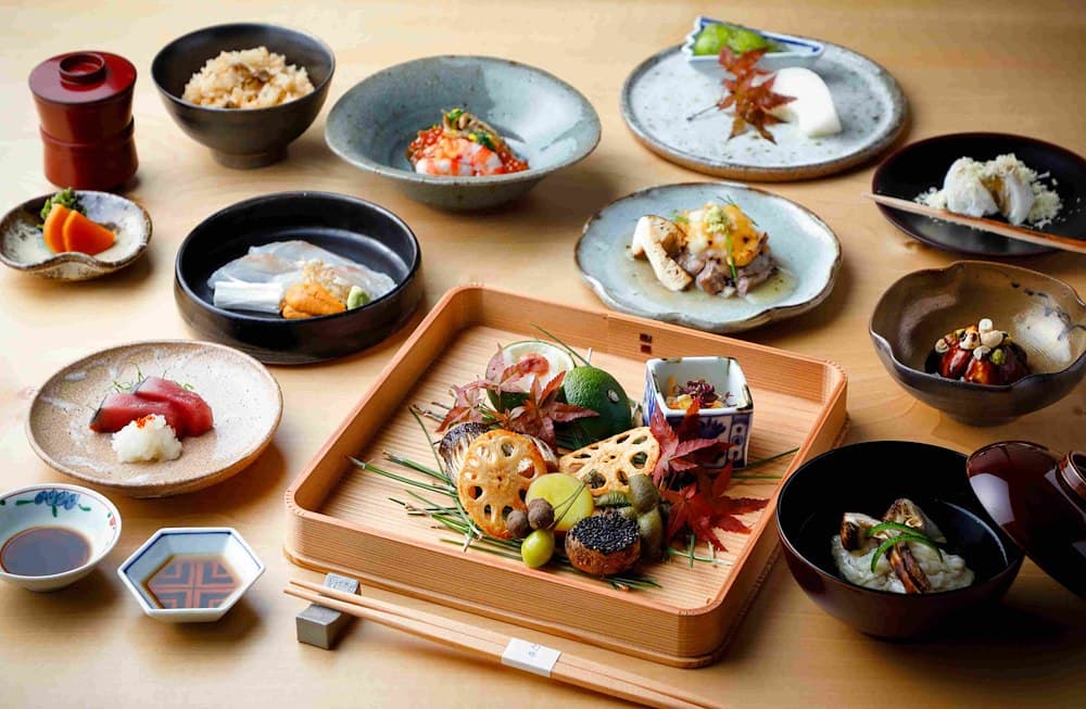 Artfully arranged Japanese cuisine courses on wooden board and ceramic bowls