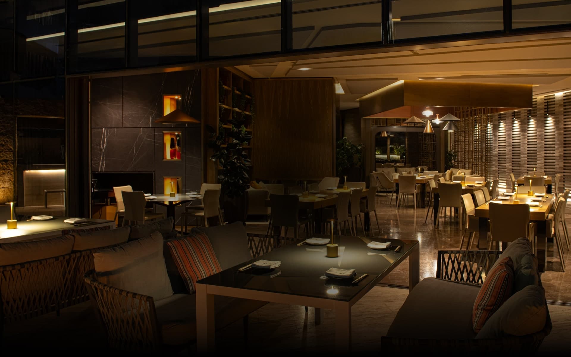 Modern fine dining restaurant interior with elegant table settings and warm ambient lighting