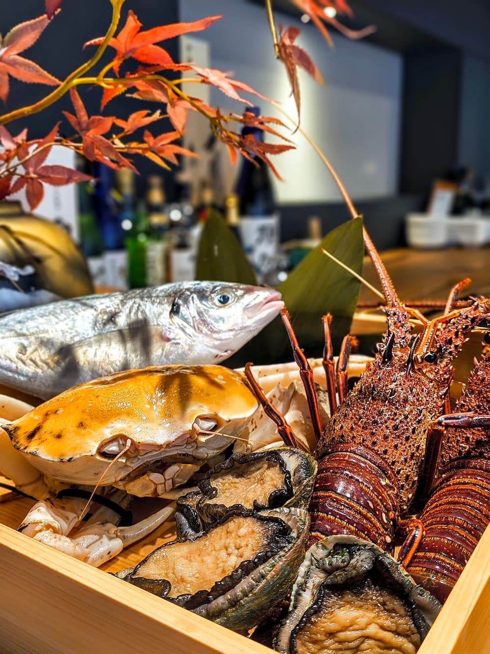 Fresh seafood display with fish, crab, and lobster arranged with decorative flowers